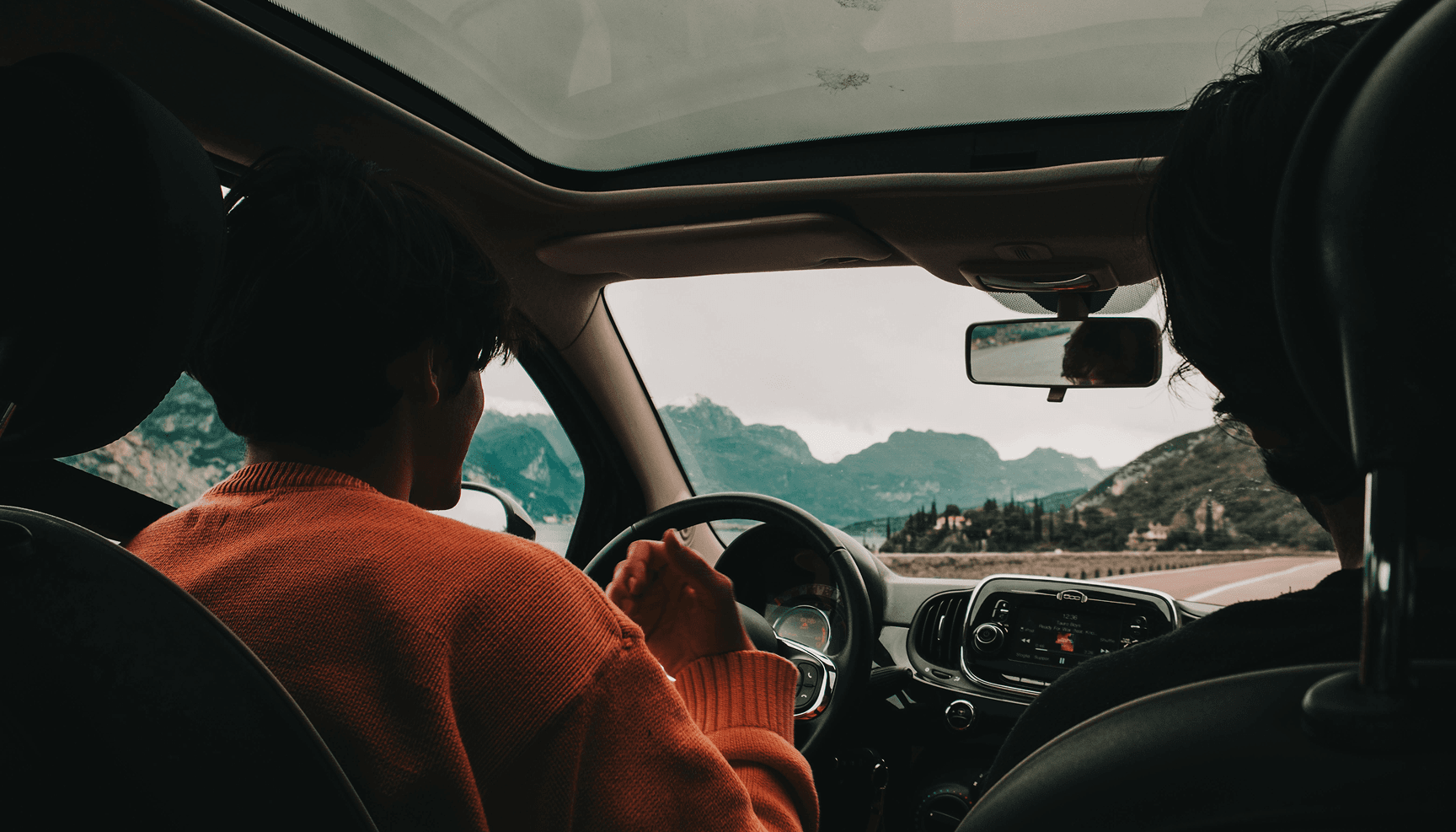 Scenic road through mountains viewed from inside a car